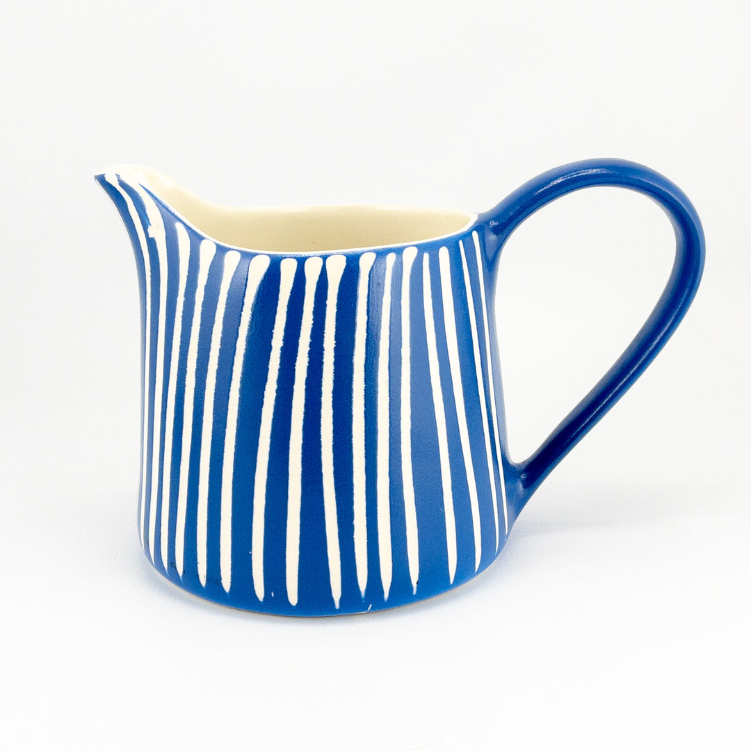 blue and white stripped milk jug.
