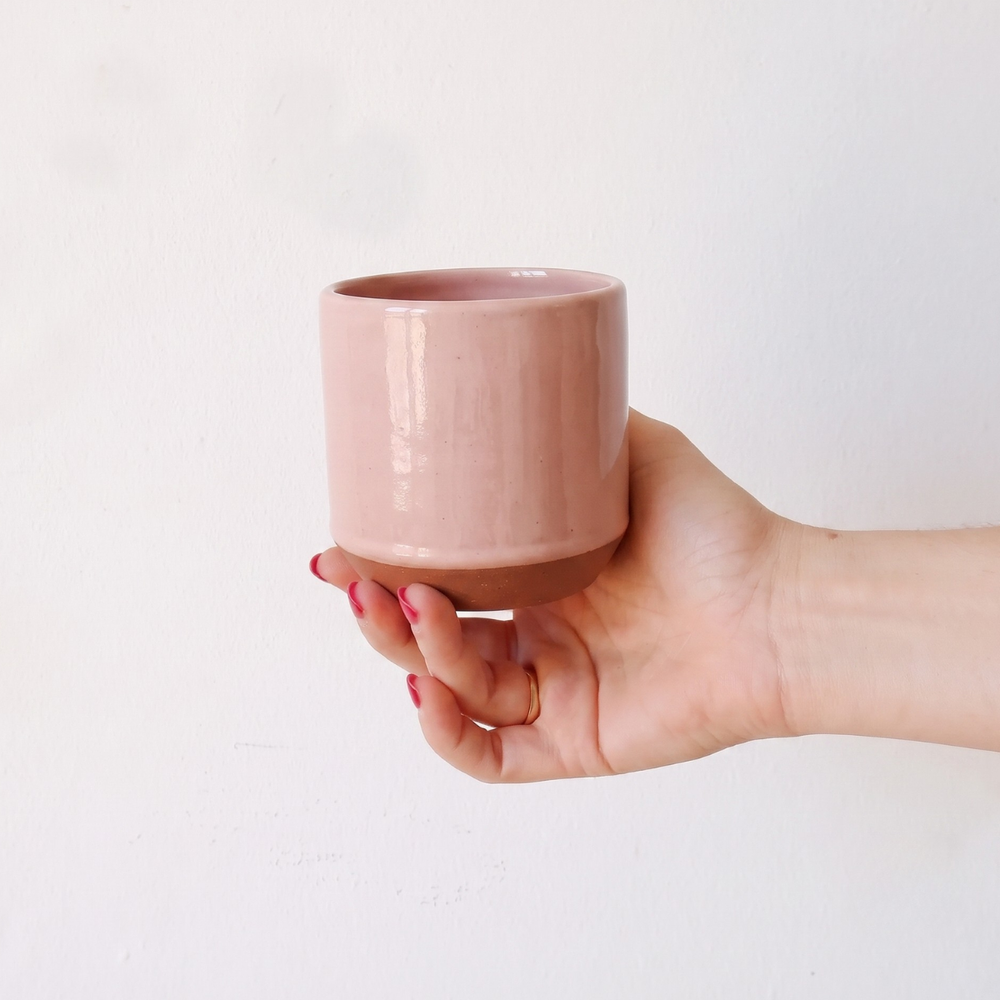 someone holding pink cup for scale