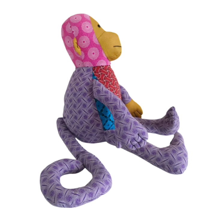 Other side of Monkey Shweshwe Stuffed Toy, with colourful fabric on white background