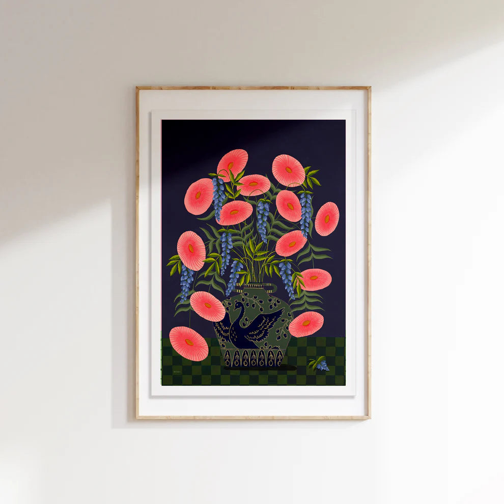 Framed fine art print of a bright pink floral display in a sage vase with a deep blue swan motif.