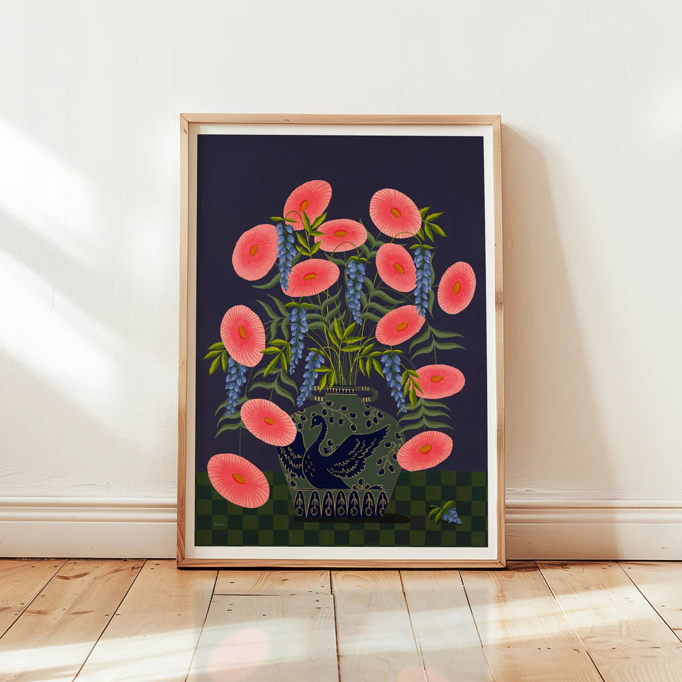 Framed fine art print of a bright pink floral display in a sage vase with a deep blue swan motif.