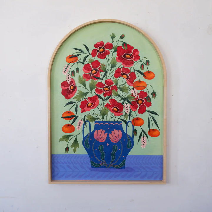 Arched Framed Fine art print of a bright burgundy floral display in a blue vase with light pink floral motif.