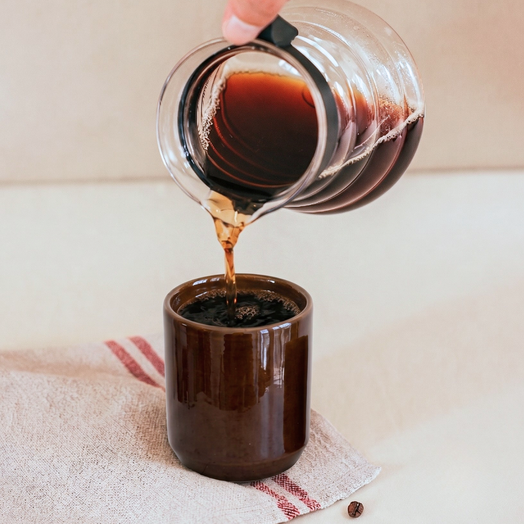 someone pouring coffee into cup