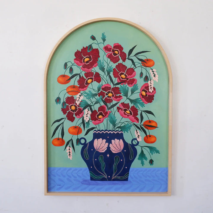Arch Framed Fine art print of a bright red floral display in a deep blue vase with light pink floral motif.
